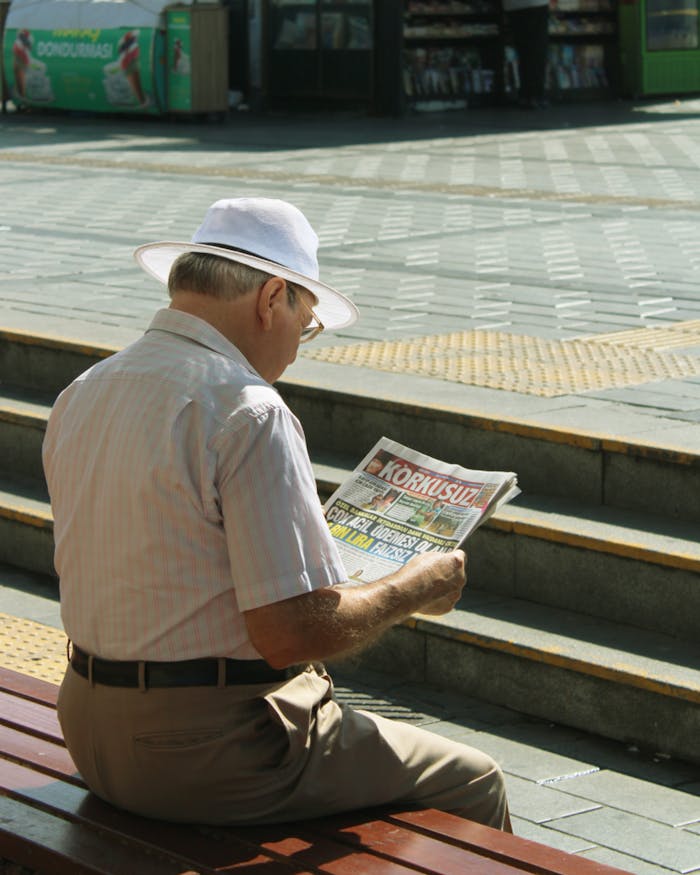 An Old Man Reading Newspaper